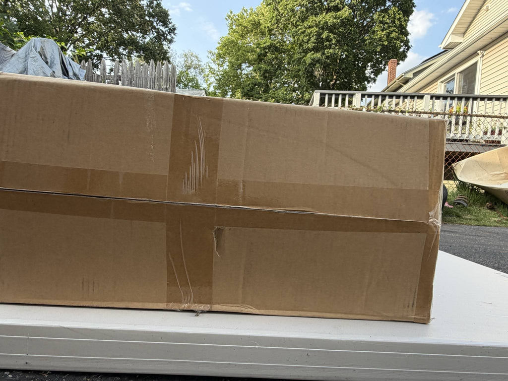CoolHut MP245 carton opposite side showing creasing, tape wear, and crushed corners