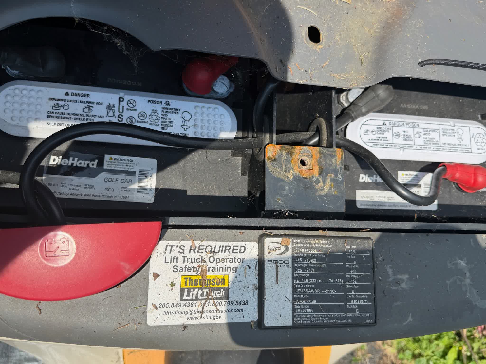 Battery compartment showing aftermarket DieHard automotive batteries