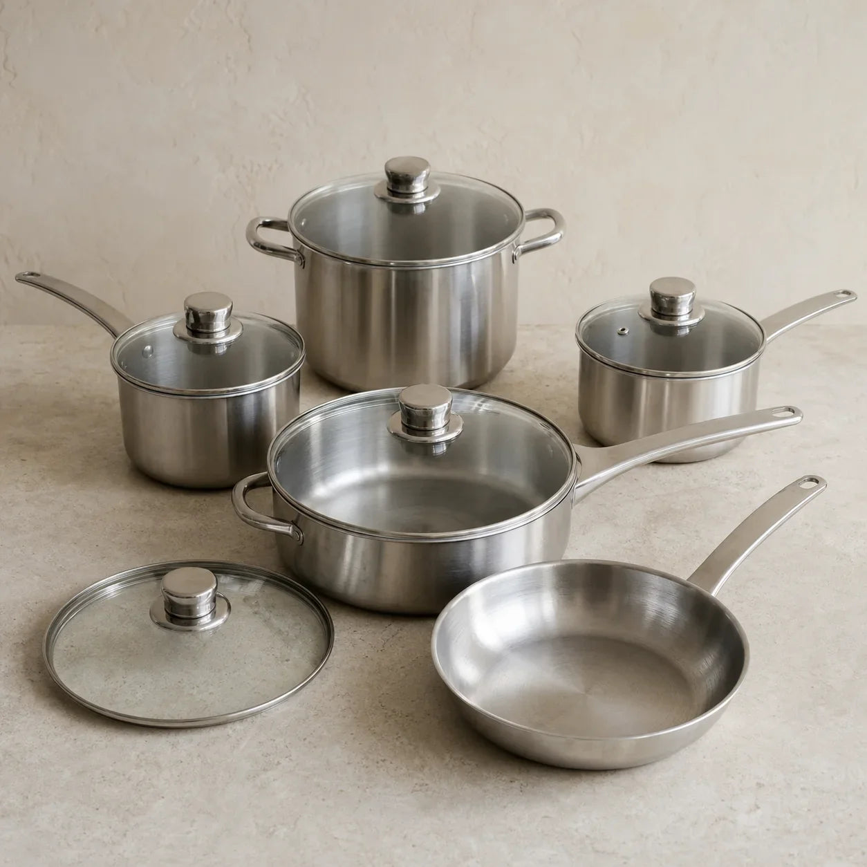 Pre-owned stainless-steel cookware set with matching lids