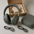Open-box olive-gray noise-canceling headphones with case and cables